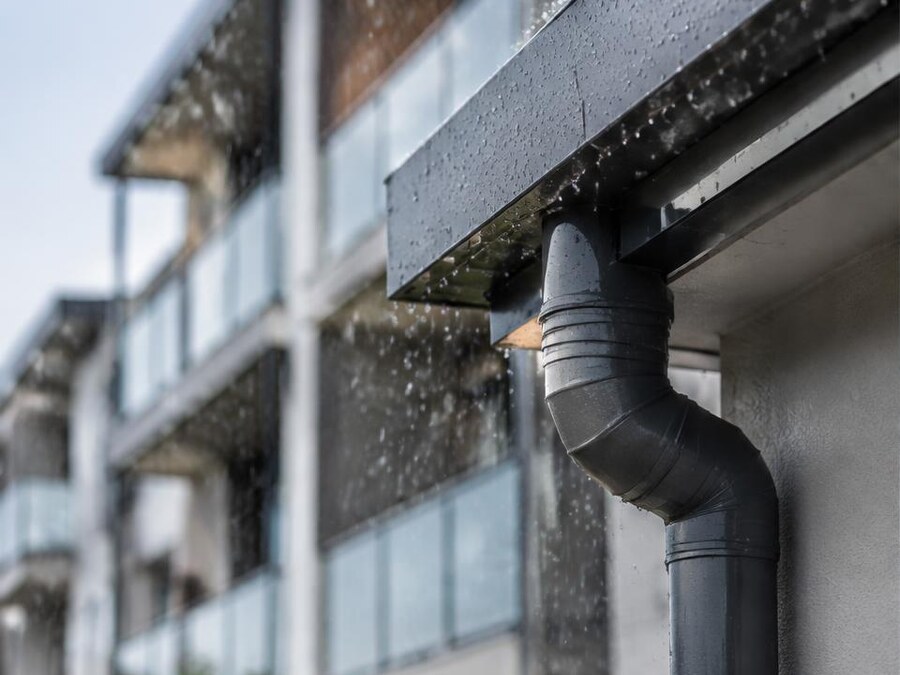 Rainwater management detail on a modern apartment façade