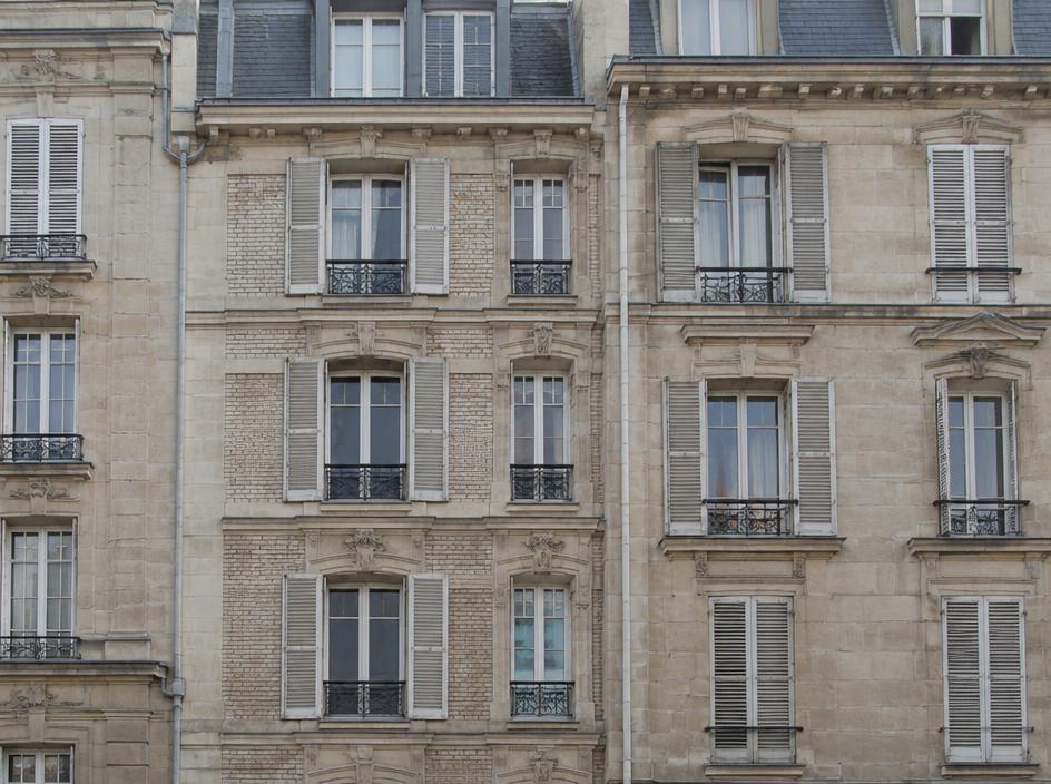 European masonry residential facade with shuttered windows