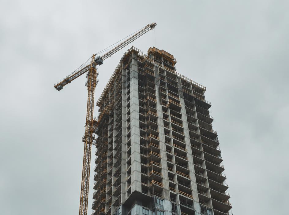 Residential tower under construction with a crane